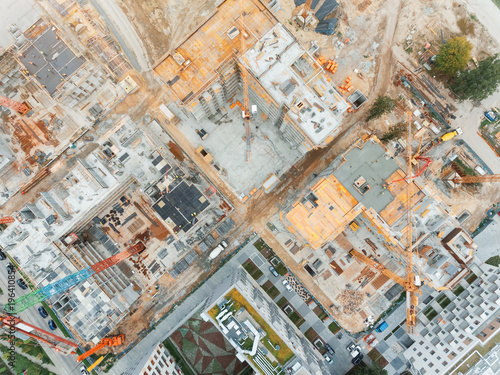 Aerial view of construction site with crane and building. Top view of big development construction and architecture.