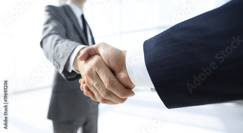 Diverse business male shaking hands.