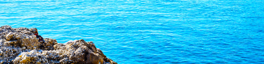 Amazing sea with blue summer wave and rocks, relaxing view of rocks and water