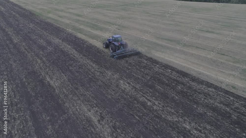 The combine removes the mote that has remained after mowing. A beautiful pattern on the ground after cutting the glass. View from above. Aerial view. 4k Video The combine removes the mote that has remained after mowing. A beautiful pattern on the ground after cutting the glass. View from above. Aerial view. 4k Video