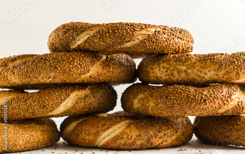 Traditional Turkish crispy bagel,simit overlaid,on the white background.Close up taken,isolated. photo