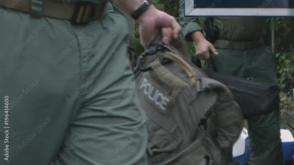 A police SWAT team get ready for training in slow motion. A police SWAT team get ready for training in slow motion.