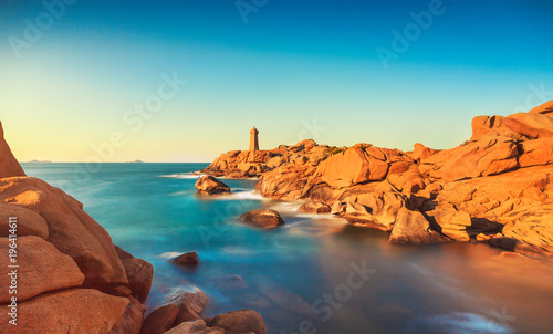 Ploumanach lighthouse sunset in pink granite coast, Brittany, France.