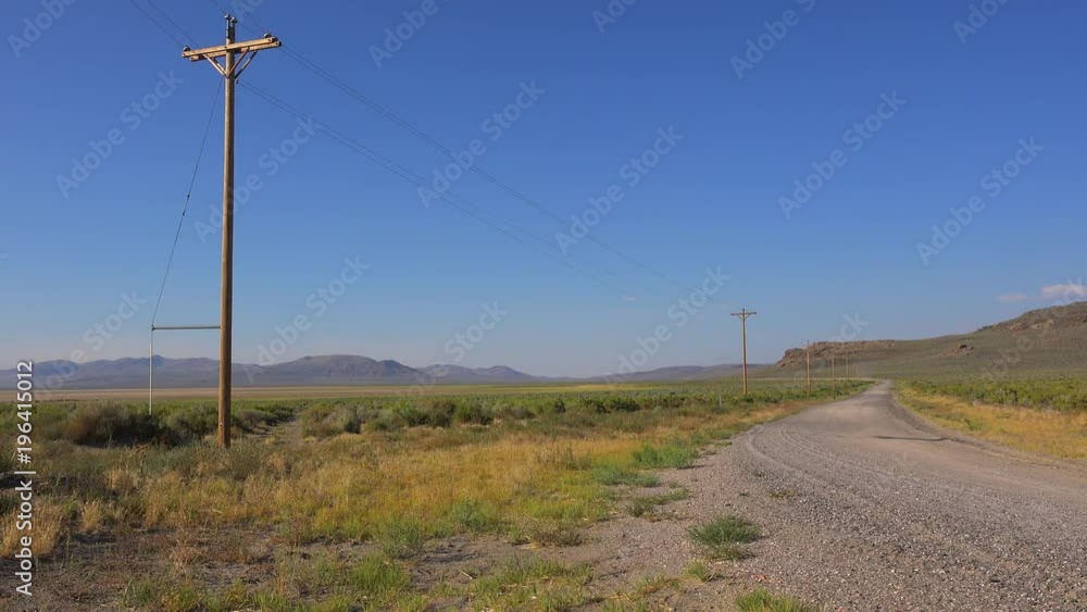 A lonely desert road is lined with telephone poles. A lonely desert road is lined with telephone poles.