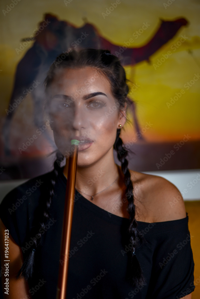 Fototapeta premium Young hot girl smoking shisha