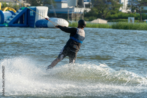 2017, April 30, Bangkok, Thailand: Man wake boarding on a lake with cable in Zanook Wake Park. photo