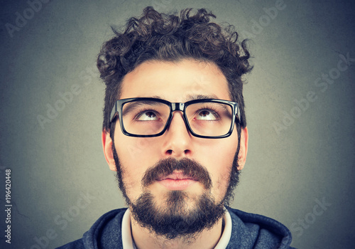 portrait of a man with glasses looking up