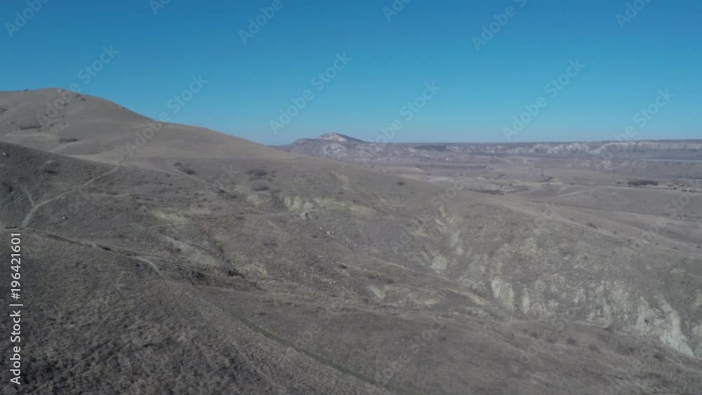 Flying out over the valley in sunny day