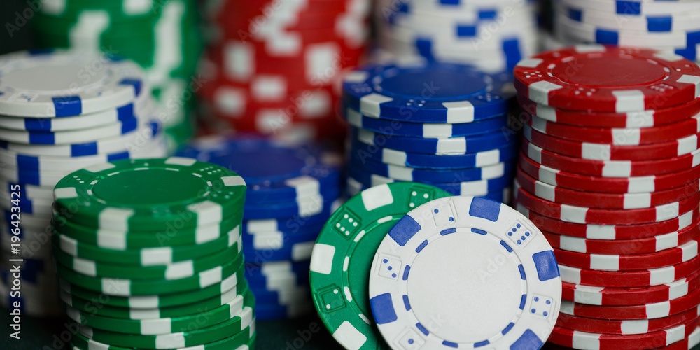 stacks of poker chips on a poker table in a casino representing a win after gambling. stacks of poker chips on a poker table in a casino representing a win after gambling.