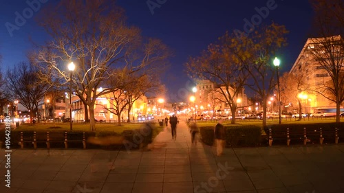 Wide motion time lapse of people walking during rush hour traffic at dusk in Dupont Circle in Washington, DC. photo