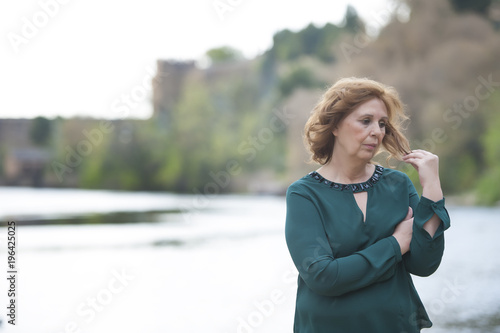 Grandmother posing near the river