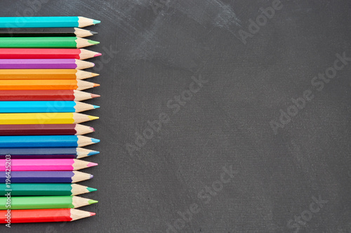 Color pencils with copy space on dark background.