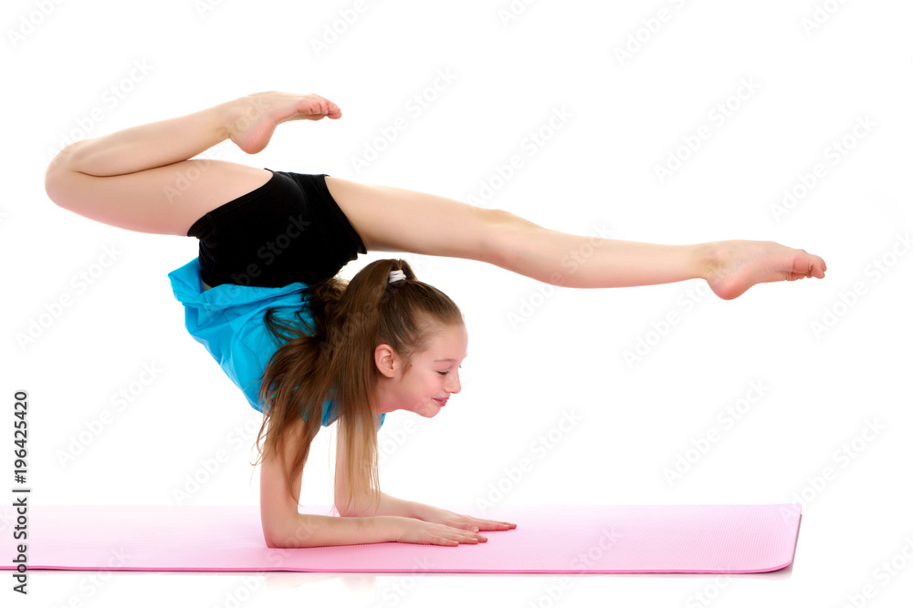 A gymnast performs an exercise stance on her forearms. A gymnast performs an exercise stance on her forearms.