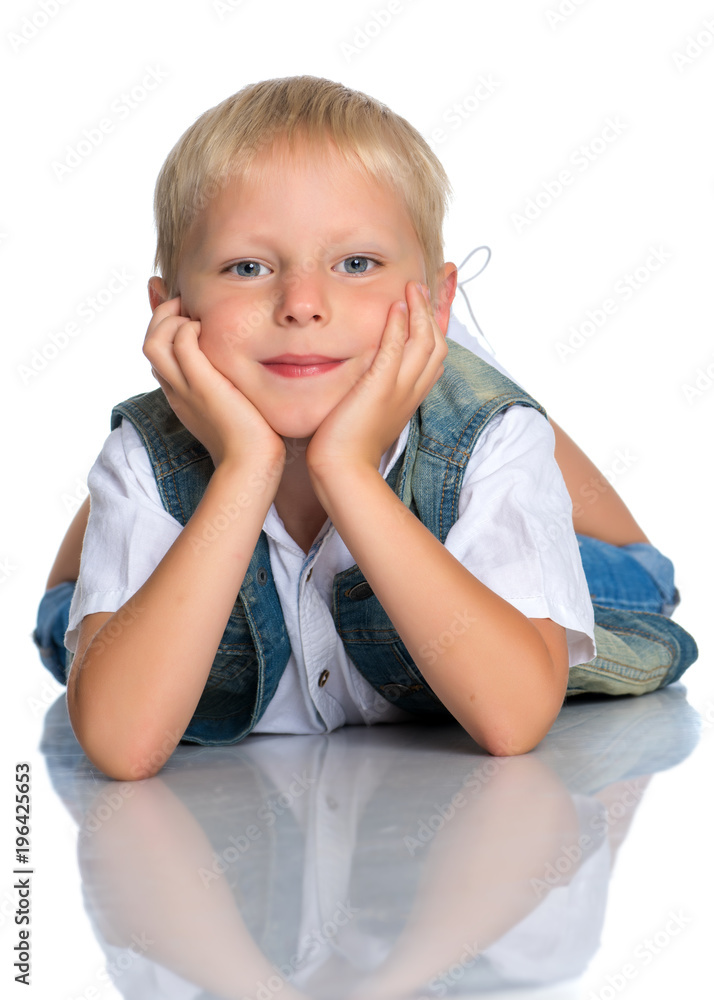 A little boy is lying on the floor in the studio. A little boy is lying on the floor in the studio.