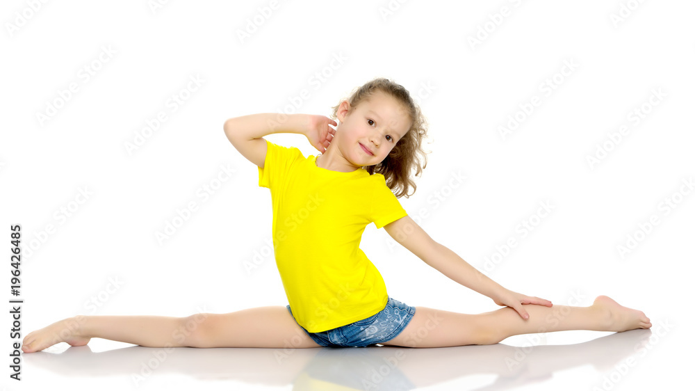 Girl gymnast perform the twine exercise. Girl gymnast perform the twine exercise.