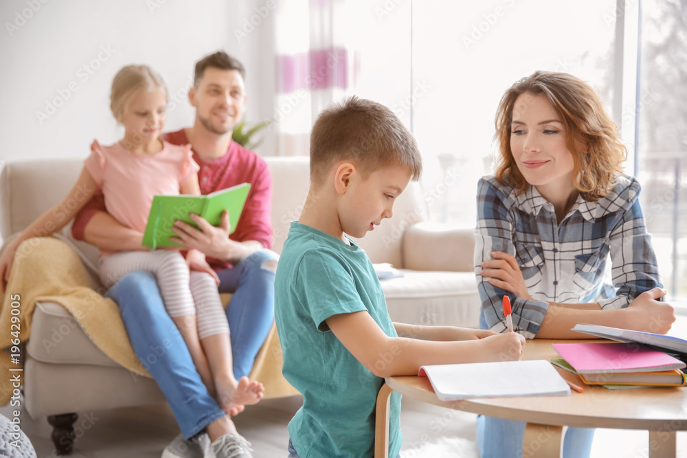 Little boy with mother doing homework at home Little boy with mother doing homework at home
