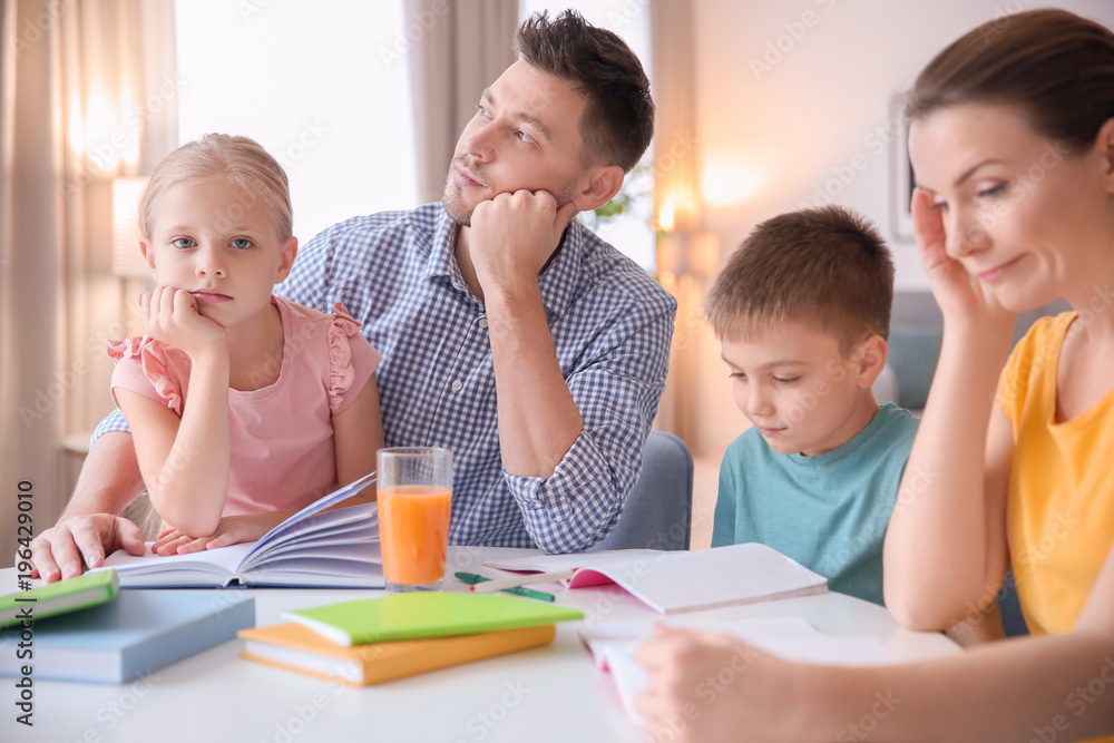 Little children with parents doing homework at home Little children with parents doing homework at home