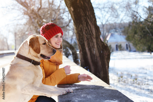 Woman walking cute dog outd...