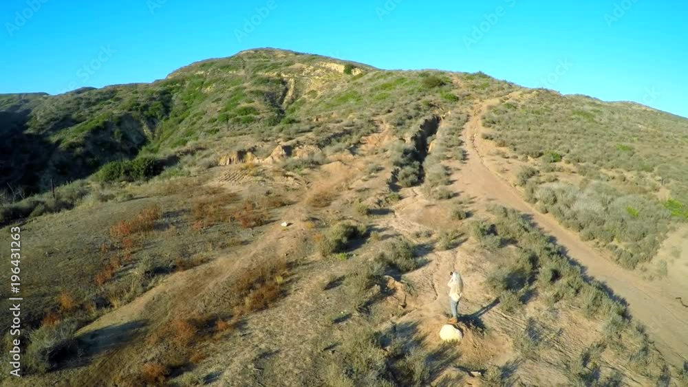 Beautiful aerial shot over the hills of Southern California with a photographer in foreground. Beautiful aerial shot over the hills of Southern California with a photographer in foreground.