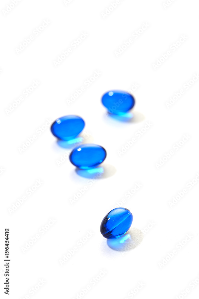 Blue pills capsule on white background Blue pills capsule on white background