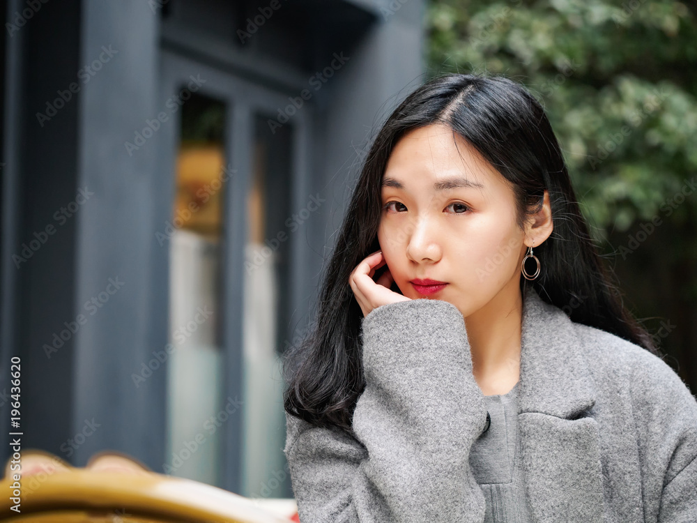 Closeup fashion beautiful Chinese woman portrait with long hair smiling and looking at camera, focus on eyes. Closeup fashion beautiful Chinese woman portrait with long hair smiling and looking at camera, focus on eyes.