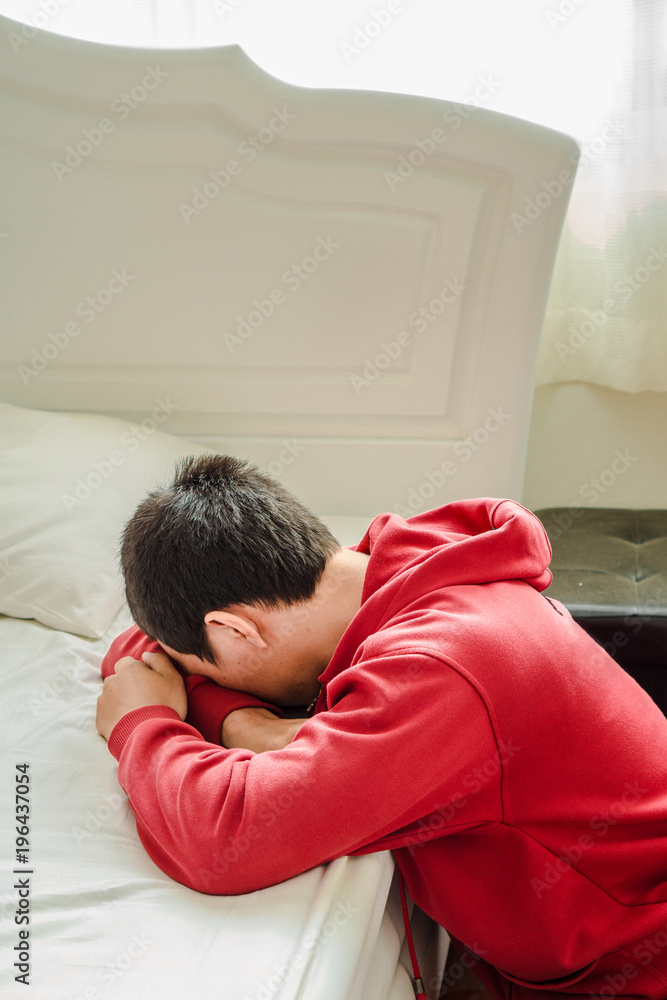 Depressed man fall face down on the bed in the bedroom Depressed man fall face down on the bed in the bedroom