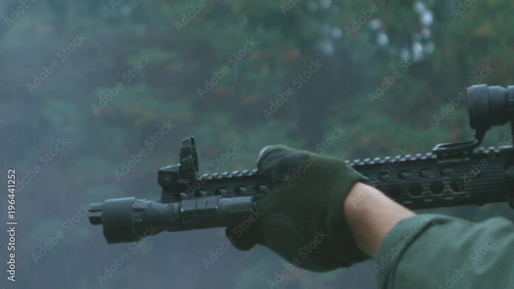 A police SWAT team office fires a rifle at a target range in super slow motion. A police SWAT team office fires a rifle at a target range in super slow motion.