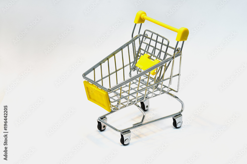 Close the grocery store in the supermarket and push the shopping cart with the yellow handle isolated from the White background. Shop concept