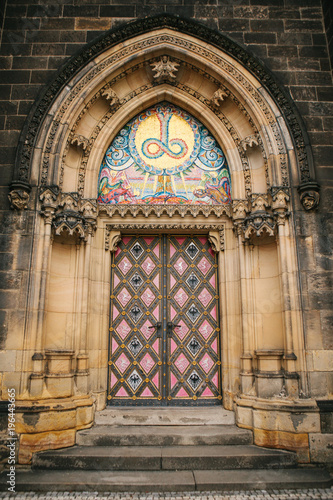 A beautiful antique door to the Catholic cathedral located in the High City called Vysehrad in Prague. Entrance to the cathedral. photo