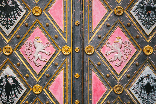 A beautiful antique door to the Catholic cathedral located in the High City called Vysehrad in Prague. Entrance to the cathedral. photo