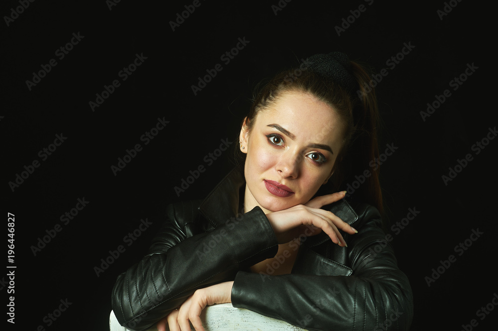 portrait of a young woman on a dark background portrait of a young woman on a dark background