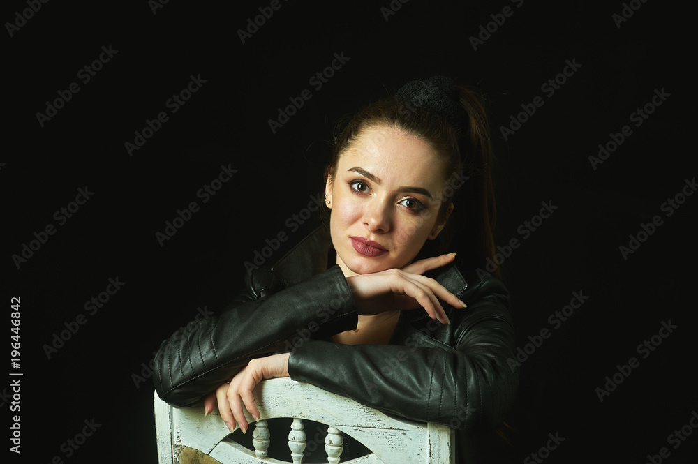 portrait of a young woman on a dark background portrait of a young woman on a dark background