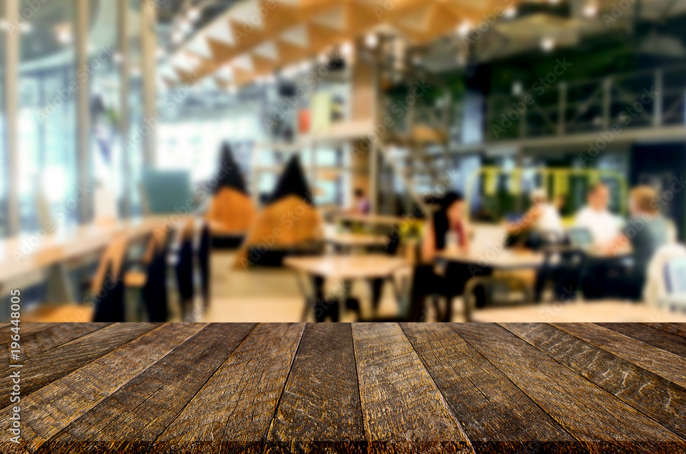 Selected focus empty brown wooden table and Coffee shop or restaurant blur background with bokeh image. for your photomontage or product display.