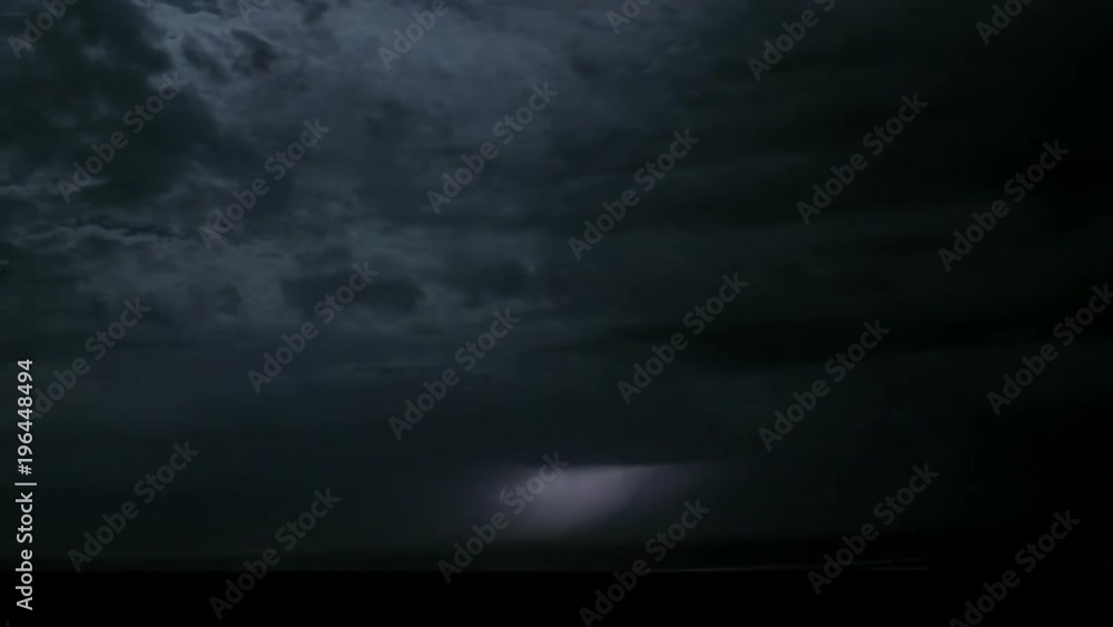 Lightning flashes under fast-moving storm clouds. Lightning flashes under fast-moving storm clouds.