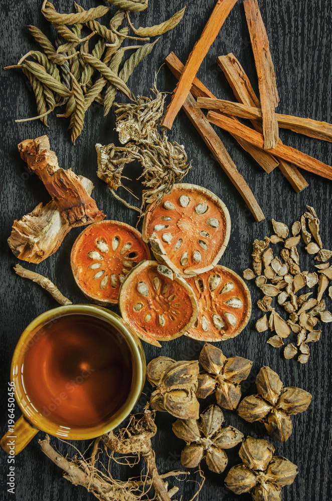 Dried herbs and Ginseng, Top view of Thai herbs and ginseng on wooden floor. Slices of dries root for make a herb juice on the dark table. Dried herbs and Ginseng, Top view of Thai herbs and ginseng on wooden floor. Slices of dries root for make a herb juice on the dark table.