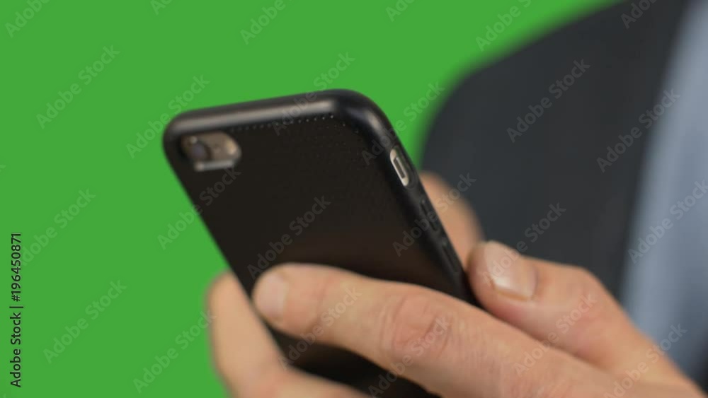 Close up male hand using screen smartphone for typing message green background. Alpha channel, keyed green screen. Close up male hand using screen smartphone for typing message green background. Alpha channel, keyed green screen.