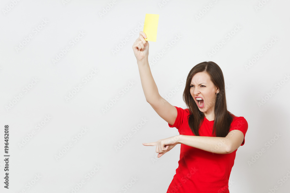 European serious severe young woman, football referee in red uniform show yellow soccer card, propose player retire from field isolated on white background. Sport, play, healthy lifestyle concept. European serious severe young woman, football referee in red uniform show yellow soccer card, propose player retire from field isolated on white background. Sport, play, healthy lifestyle concept.