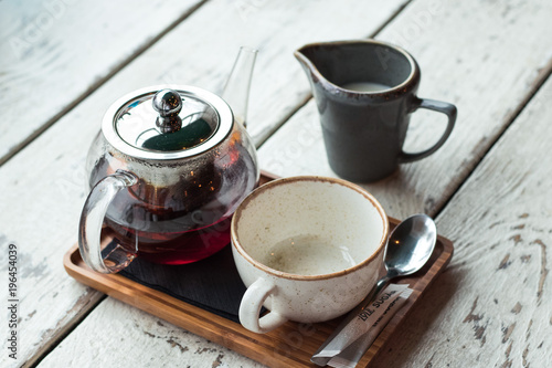 cup of tea with teapot and milk