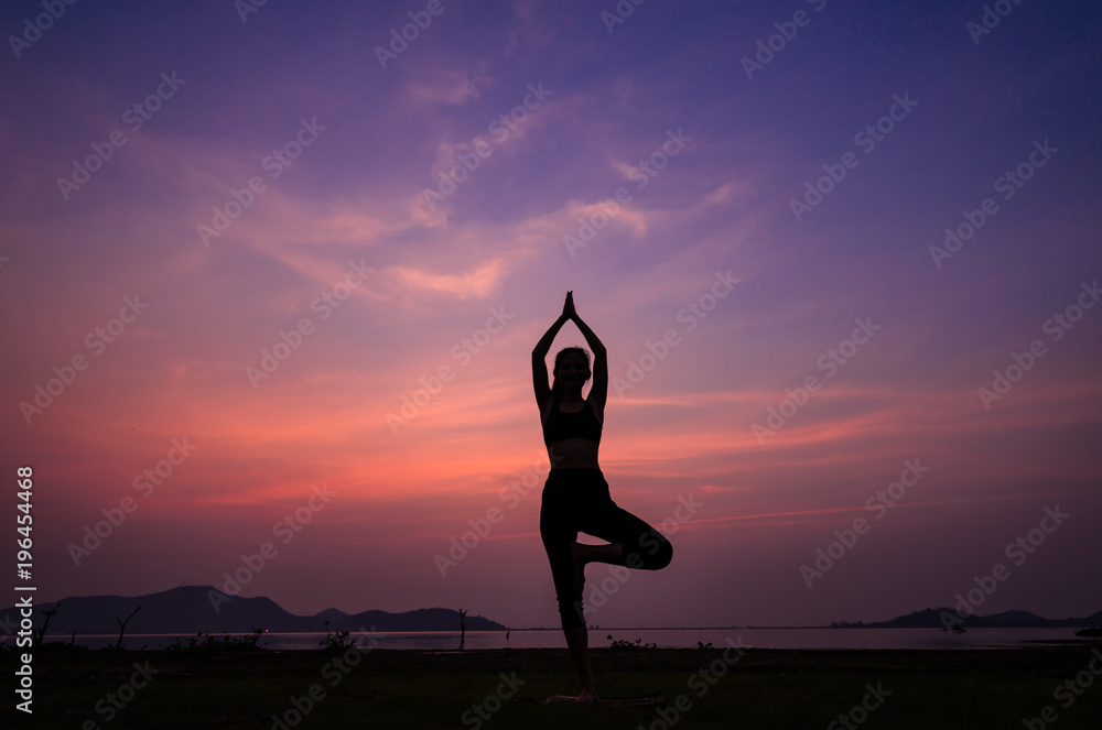 Silhouette Asia woman yoga on the beach