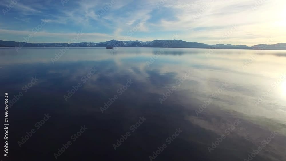 A beautiful aerial shot over Lake Tahoe in winter with a paddlewheel steamboat in distance. A beautiful aerial shot over Lake Tahoe in winter with a paddlewheel steamboat in distance.