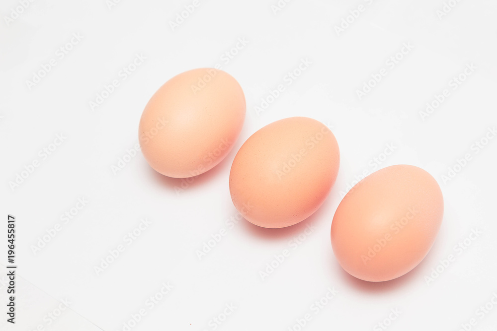 three chicken eggs on a white background