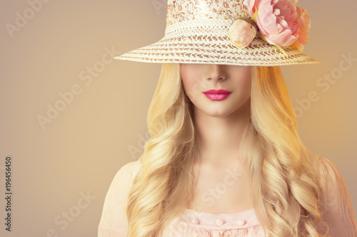 Fashion Model in Broad Brim Hat with Peony Flowers, Beautiful Woman Retro Makeup Red Lips and Long Hair photo