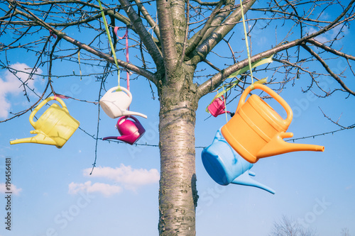 Hängende bunte Gießkannen