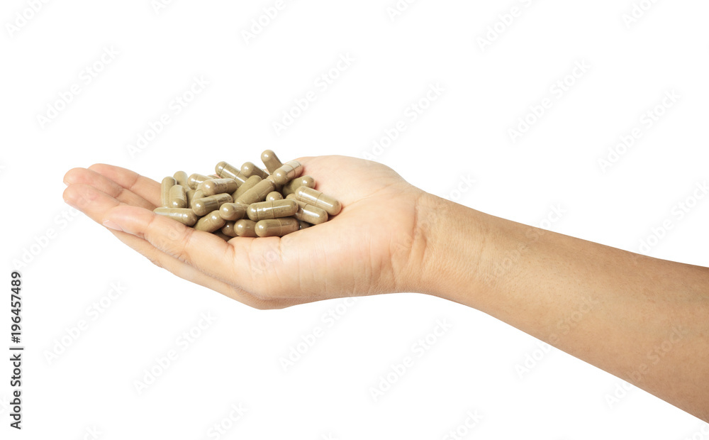 Hand with a pill herb capsules isolated with clipping path. Hand with a pill herb capsules isolated with clipping path.