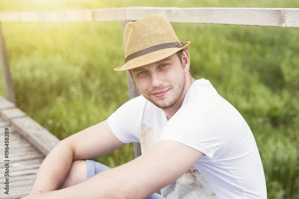 Portrait of smiling handsome man sitting outdoor