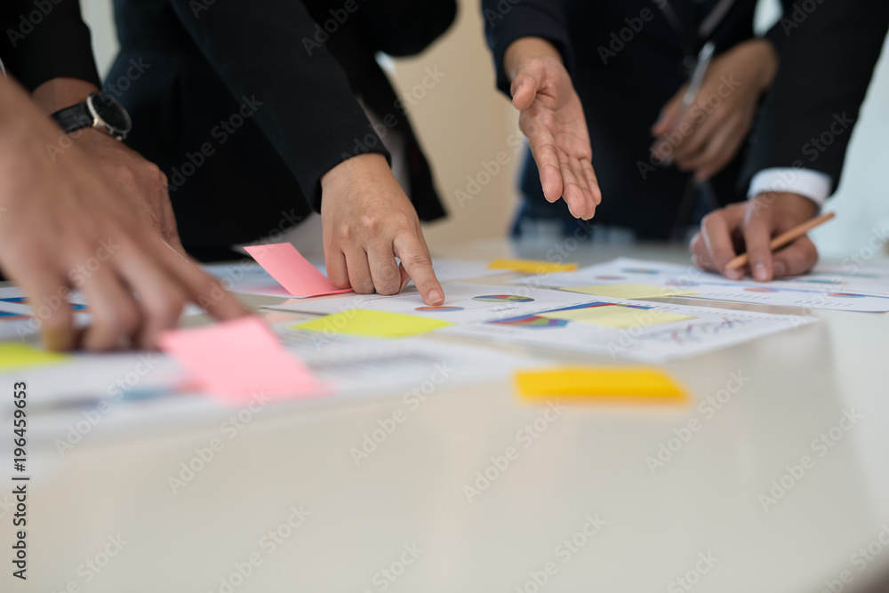 Hand of Business man and Business woman working on Data Charts,document at office desk. analyzing brainstorming, meeting concept. Hand of Business man and Business woman working on Data Charts,document at office desk. analyzing brainstorming, meeting concept.