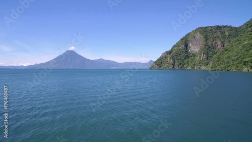 Aerial over Lake Amatitlan in Guatemala reveals the Pacaya Volcano in the distance. photo