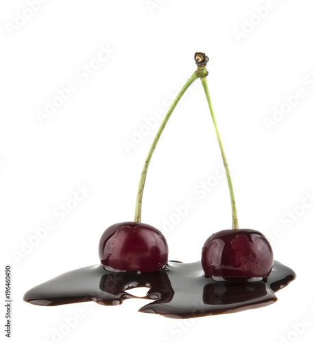 red cherry in liquid chocolate isolated on white background