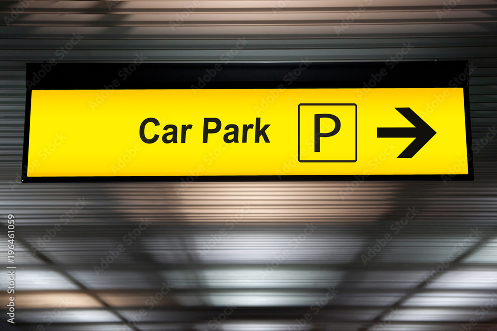 yellow car park sign with arrow pointing to car parking zone at airport terminal yellow car park sign with arrow pointing to car parking zone at airport terminal