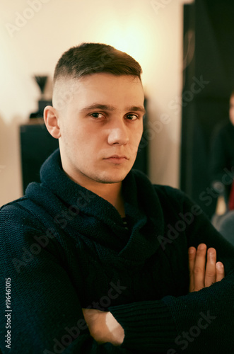 Portrait of handsome young man in black sweater